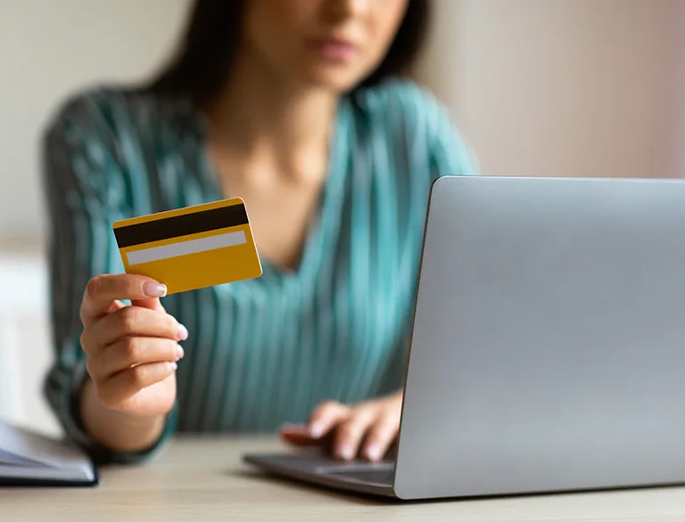 woman holding credit card to order online
