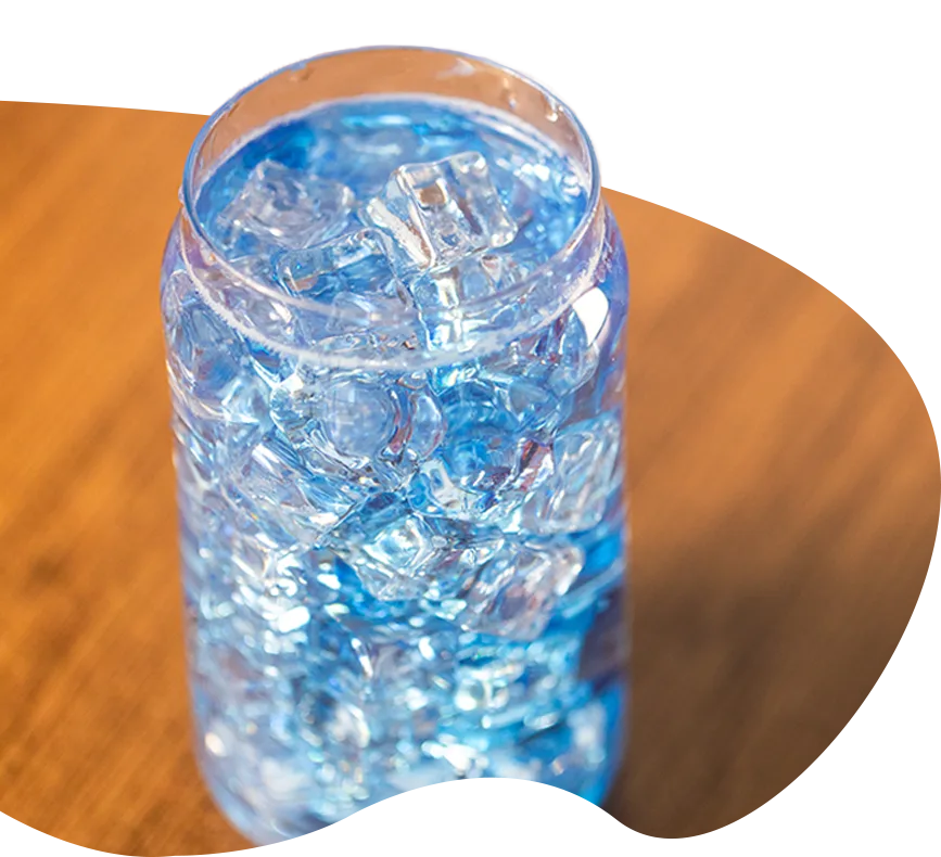bright blue drink in glass with ice